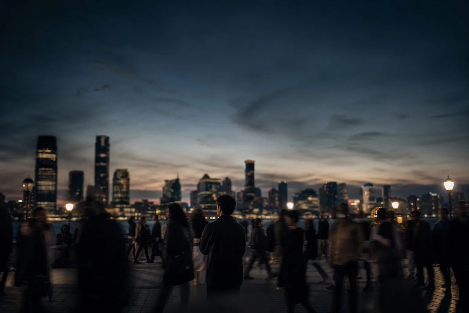 A calm person standing still in a busy public space